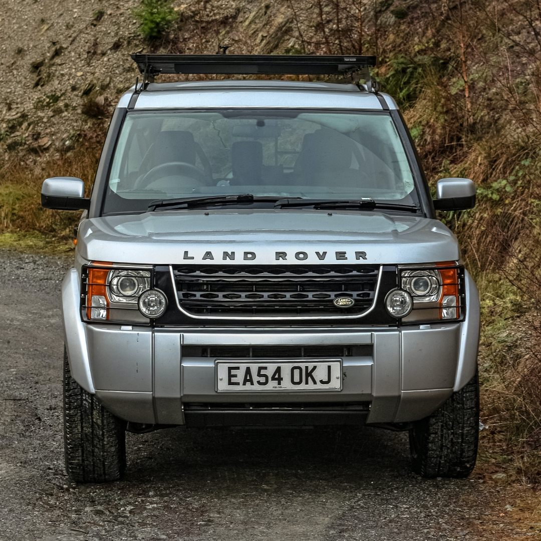 A silver Land Rover parked face first protected by a Moving Intelligence ant-theft system.