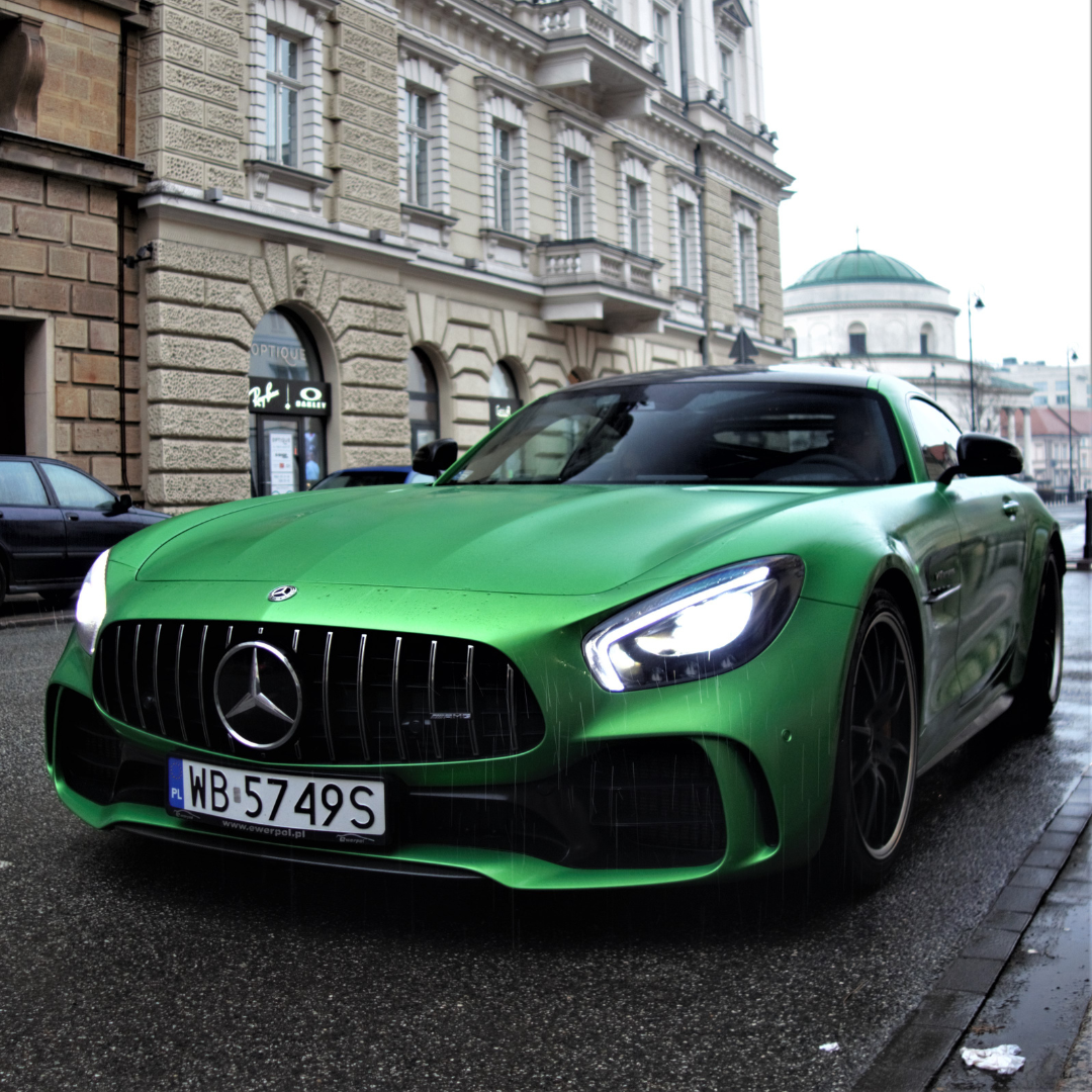 A green Mercedes driving through London protected by a Moving Intelligence tracking system.